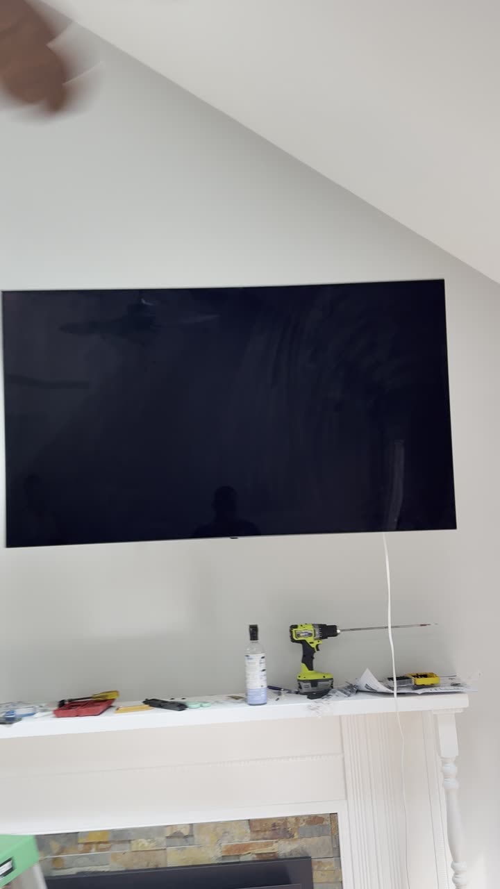 Wall-mounted television installed in a home
